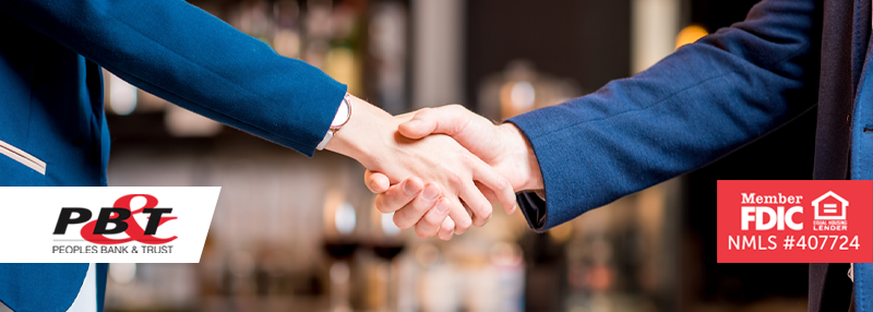 Community business banker shaking hands with business owner, only arms and hands in view